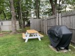 Fenced in yard with new picnic table and new gass grill 